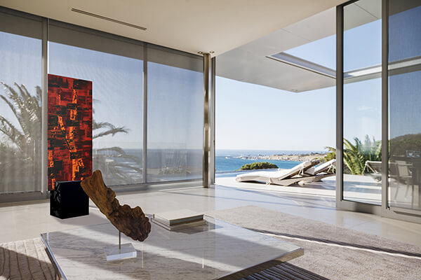 Modern living room and patio overlooking ocean